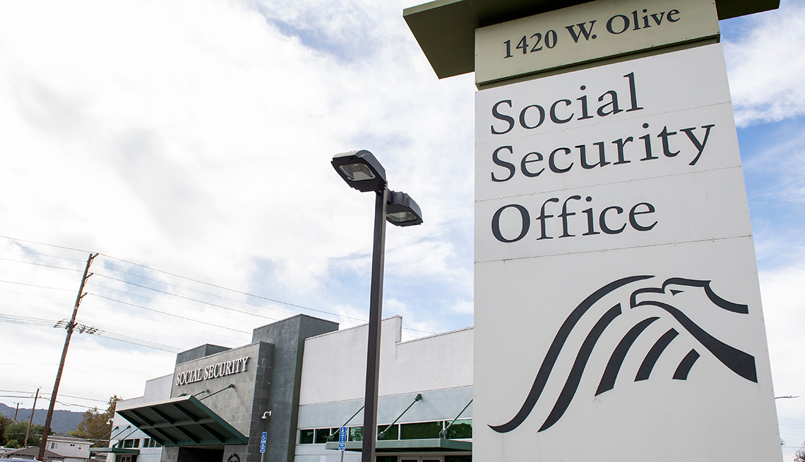 A Social Security Administration field office building exterior with the SSA sign visible near the entrance on a clear daytime street scene
