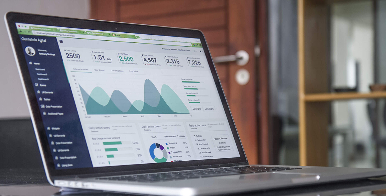 A freelancer at a desk using a laptop with a calculator and a notebook nearby, focusing on tracking income and retirement contributions, realistic photography style