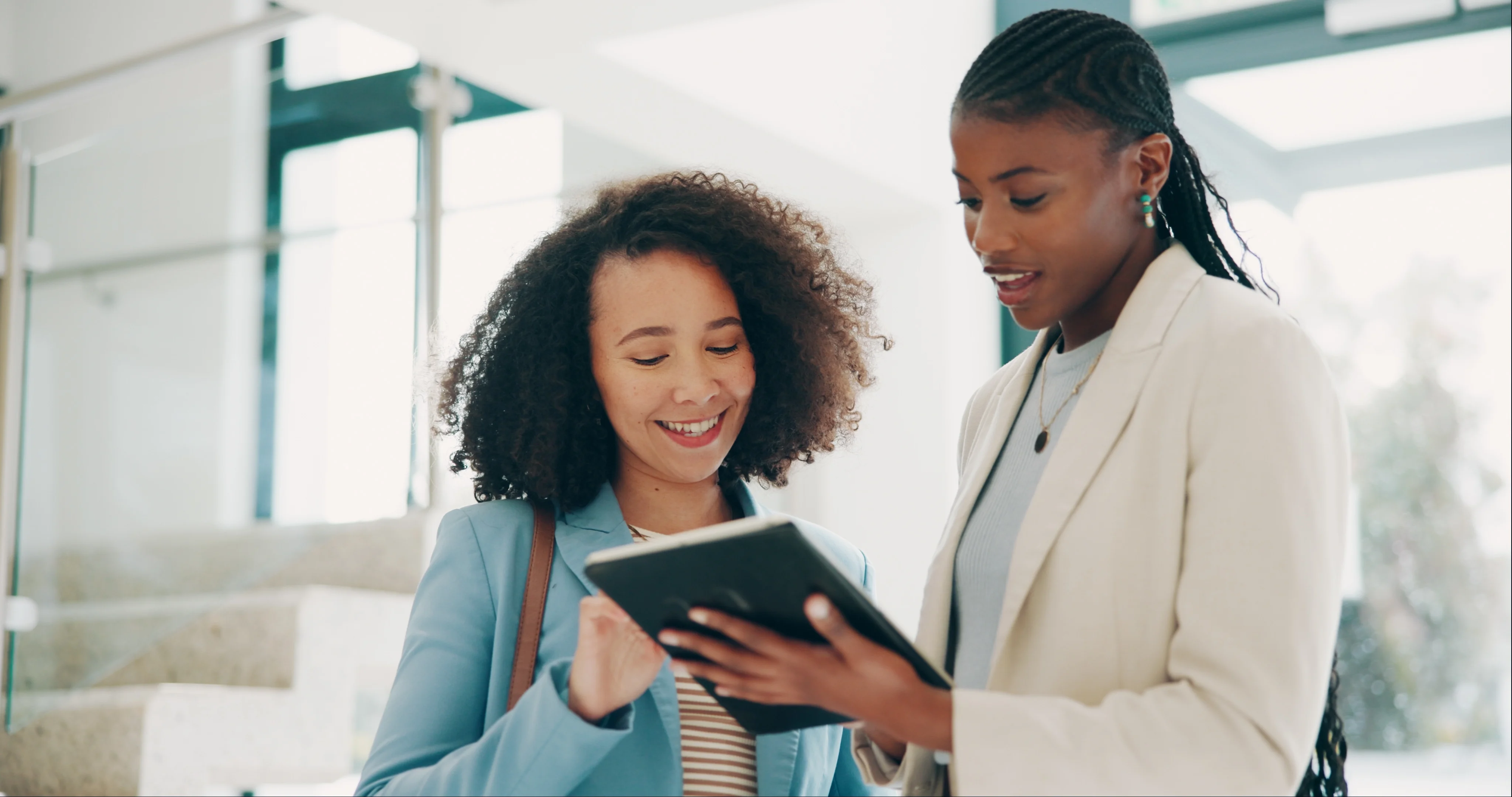 A mortgage loan officer seated across a desk from a couple, pointing to paperwork while discussing interest rate options, professional office photo