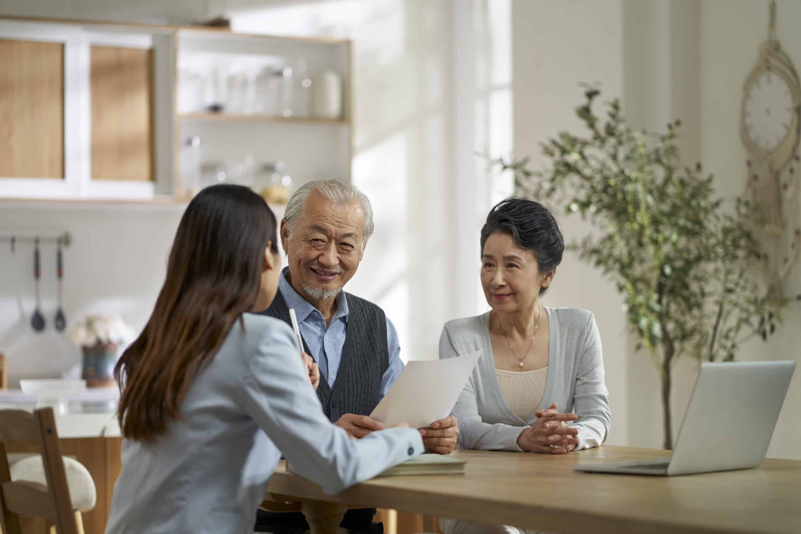 A person meeting with a financial advisor at a small office table while reviewing retirement account statements, realistic photography style