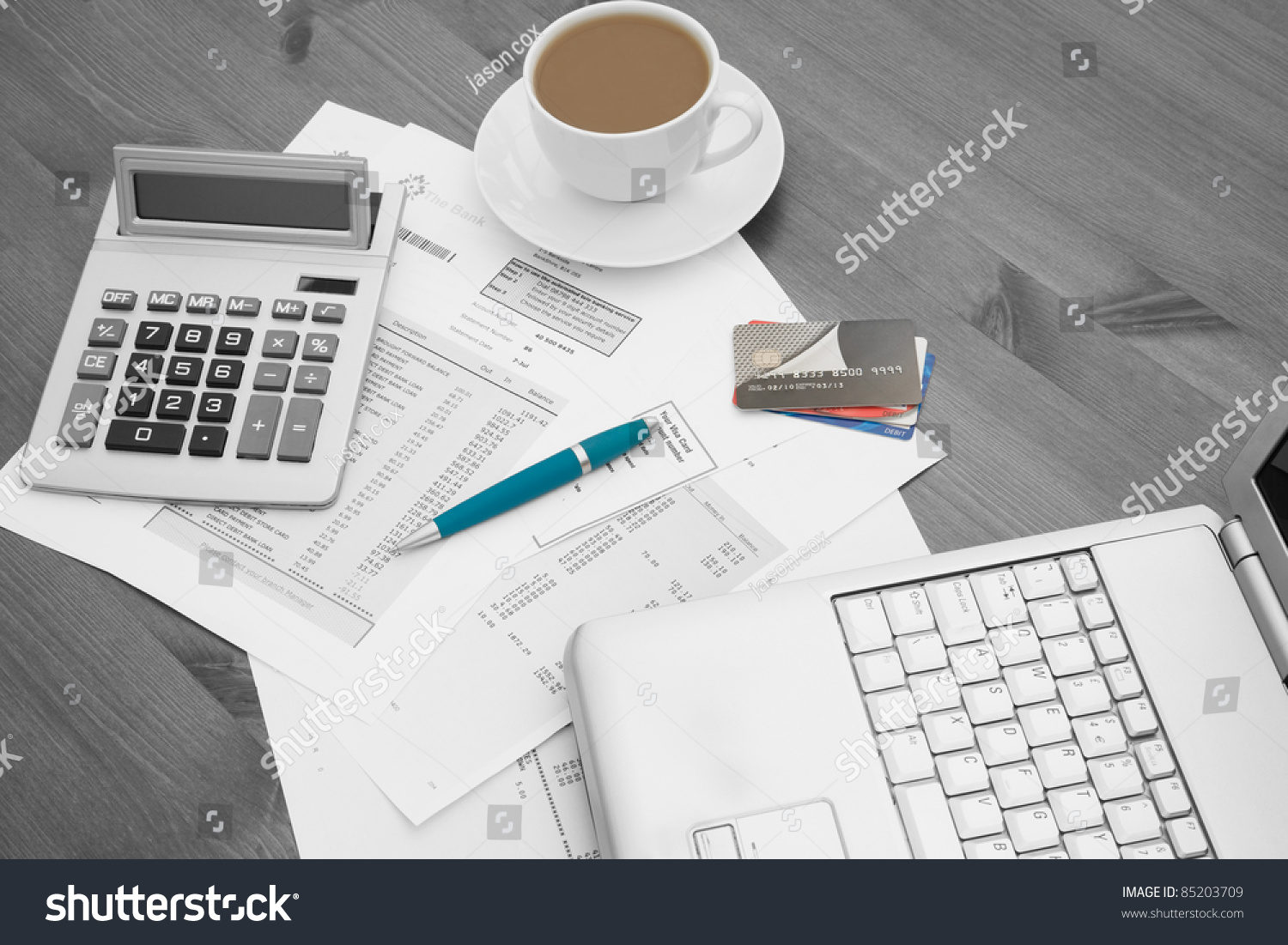 A real-life close-up photo of a credit card statement on a desk next to a calculator and pen, representing account details and payment history