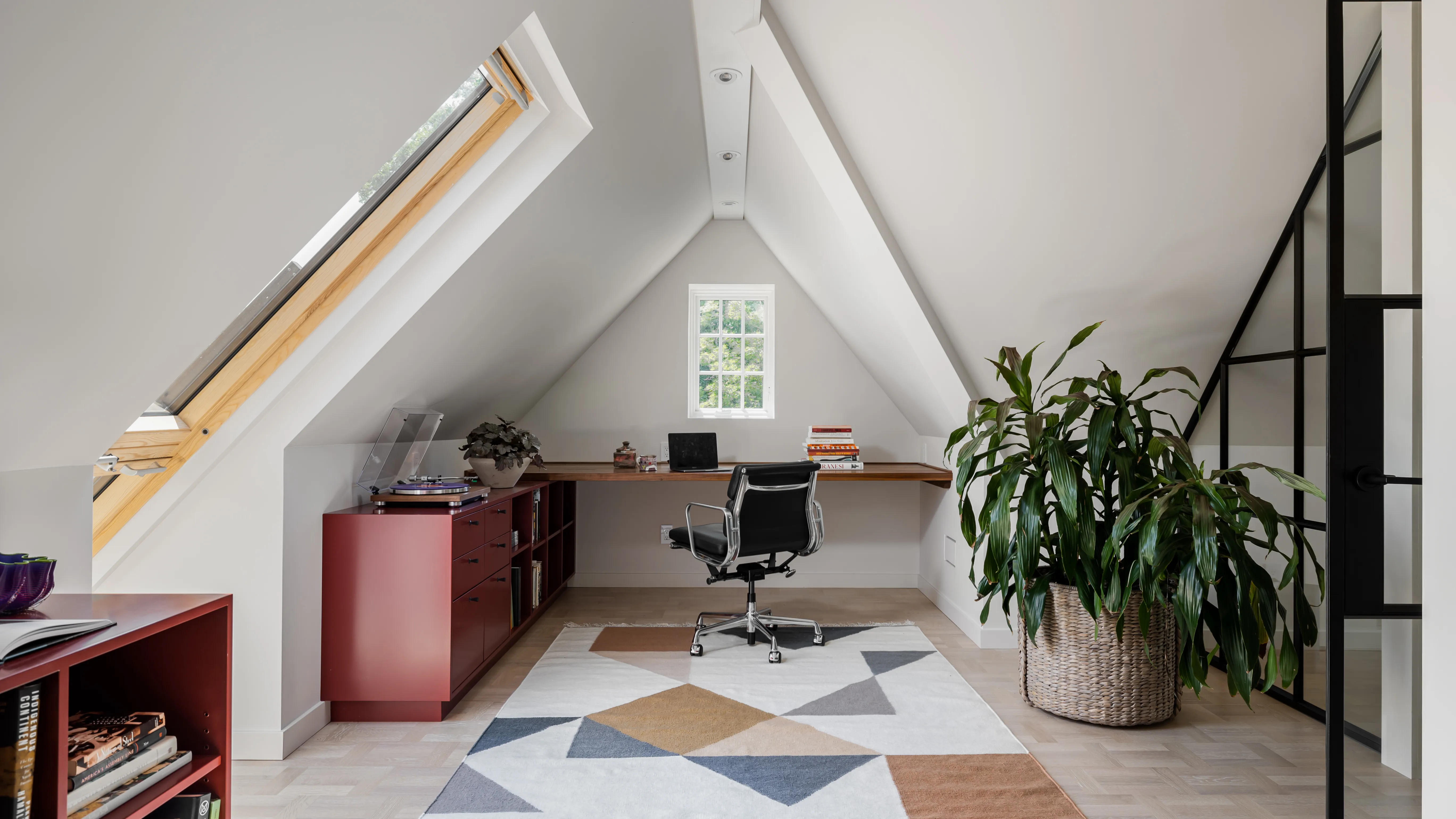 A small business owner and their spouse sitting together in a home office reviewing paperwork and a laptop screen, realistic photography style