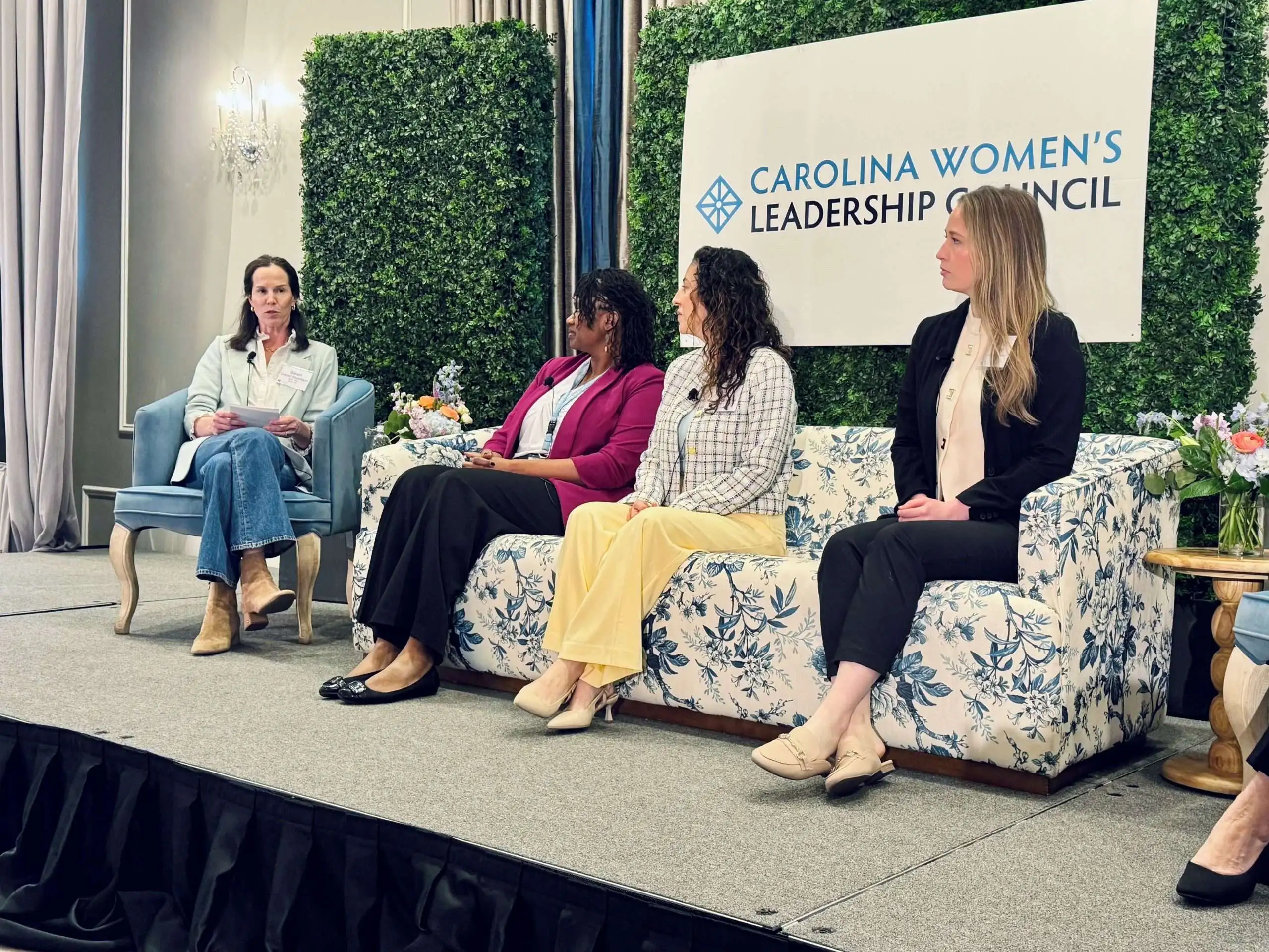 A woman sitting at a dining table reviewing a folder of inherited financial paperwork beside a notebook and pen, real-life photo