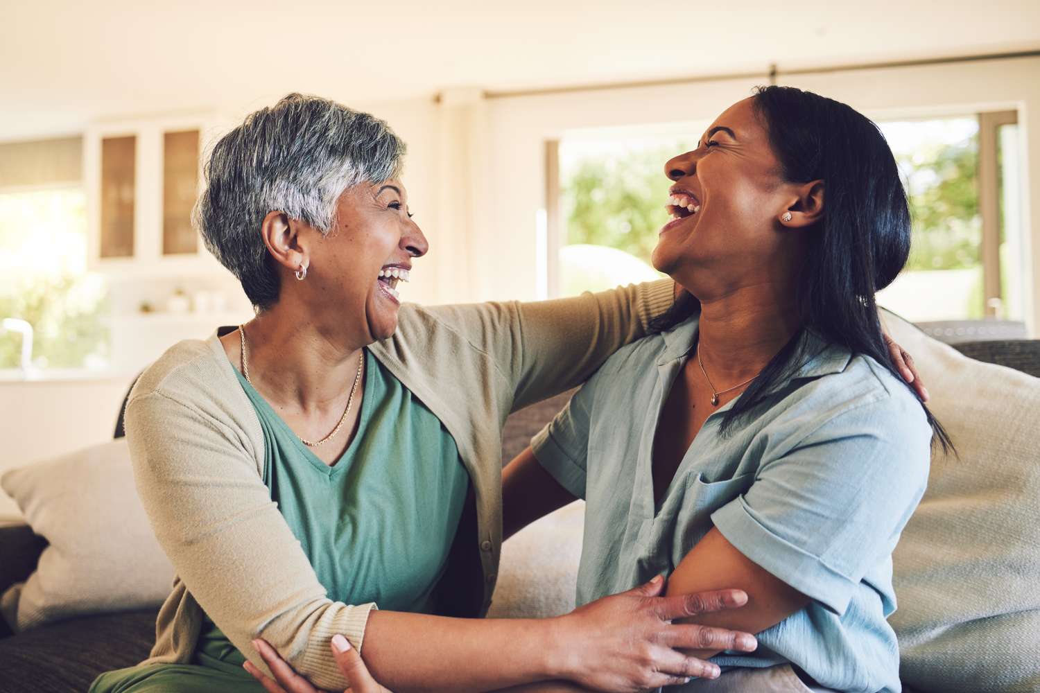 An adult child handing a paper check to a parent in a living room, candid family finance moment, natural light
