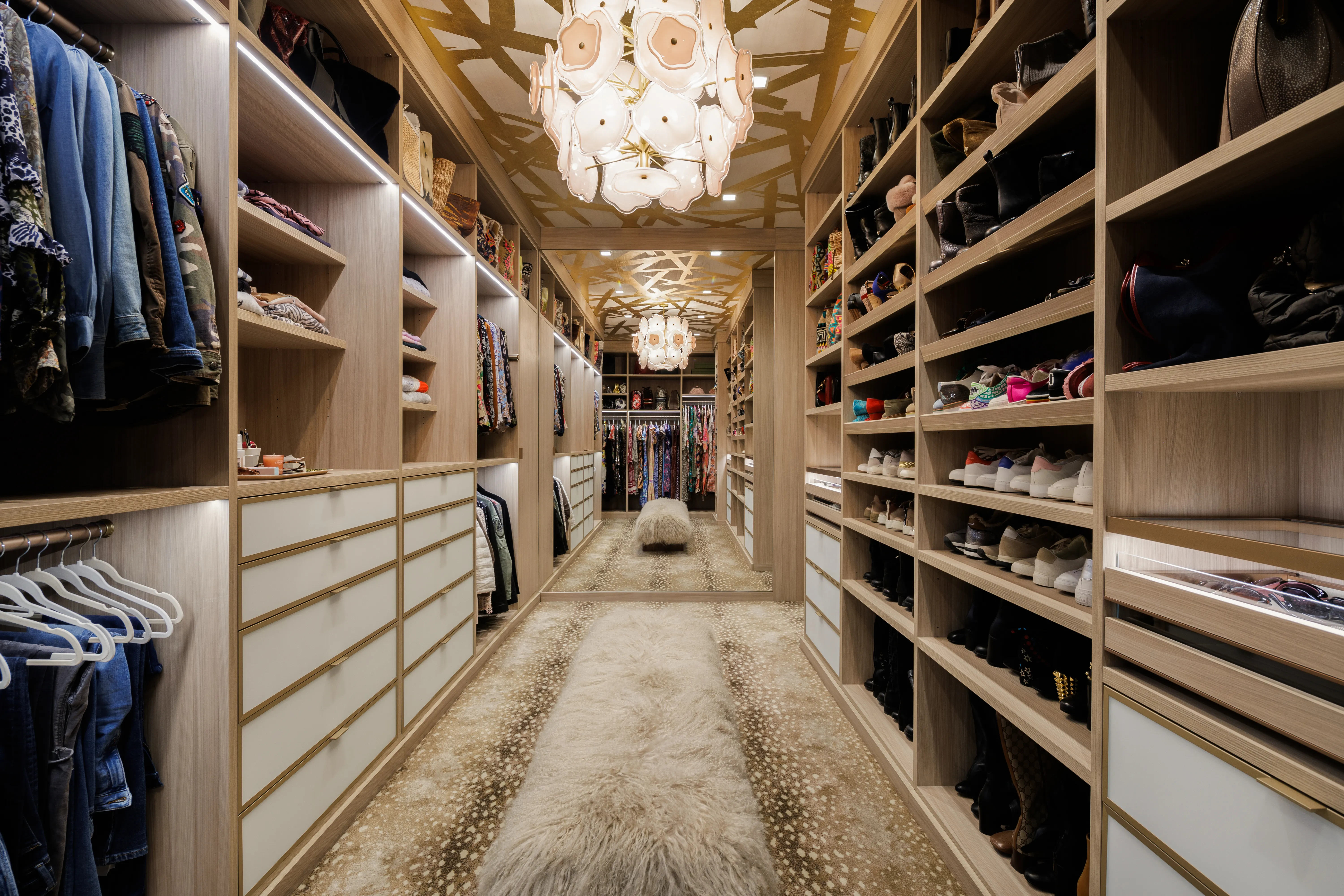 An open apartment closet with neatly arranged clothes, shoes, and storage bins on shelves, realistic indoor photo