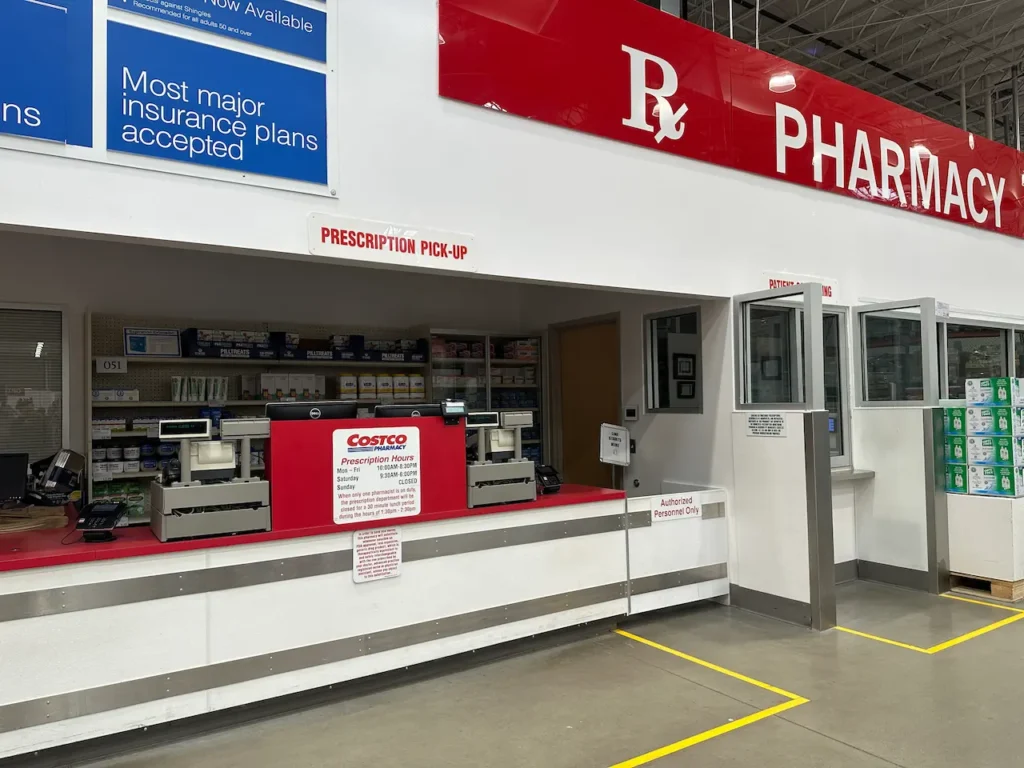 Costco pharmacy counter inside a warehouse with a prescription drop-off area.