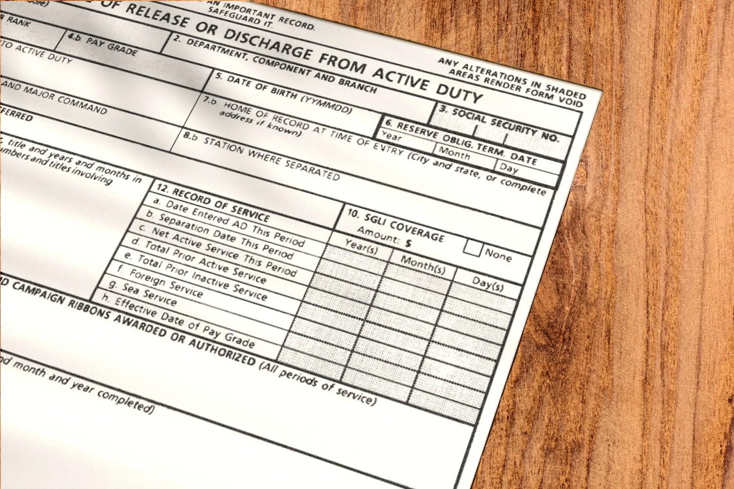 DD Form 214 discharge paperwork partially covered by a folder on a tidy desk with a calculator